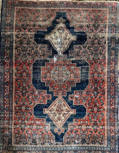 A red Oriental carpet with three medallions...