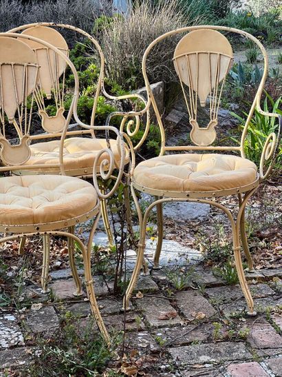 Four cream lacquered iron armchairs. Openwork...