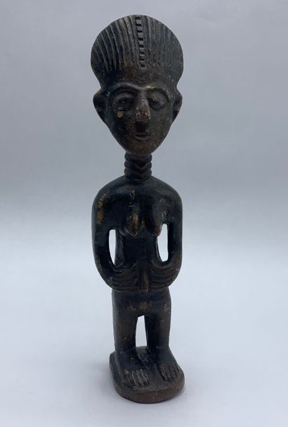 Carved wooden statuette representing a female...