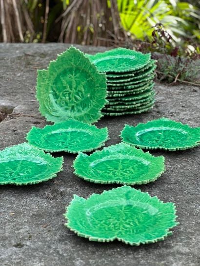 18 small green glazed earthenware leaf plates....