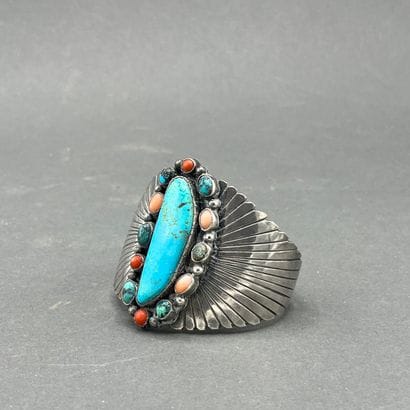 A silver and turquoise bracelet decorated...