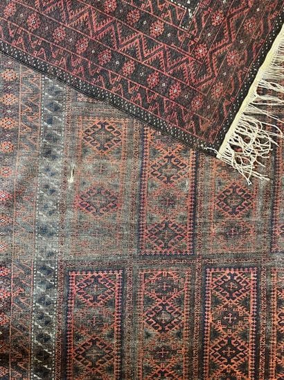 Two Persian rugs: 
- One with a red background:...