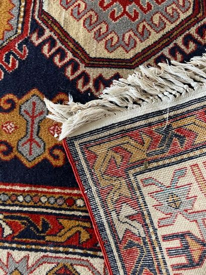Oriental rug with blue background and three...