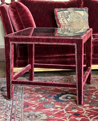 Wooden end table covered with purple velvet....