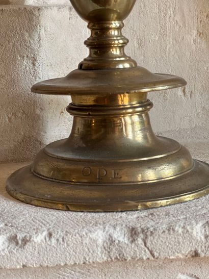 Brass pique-cierge with baluster shaft. The...