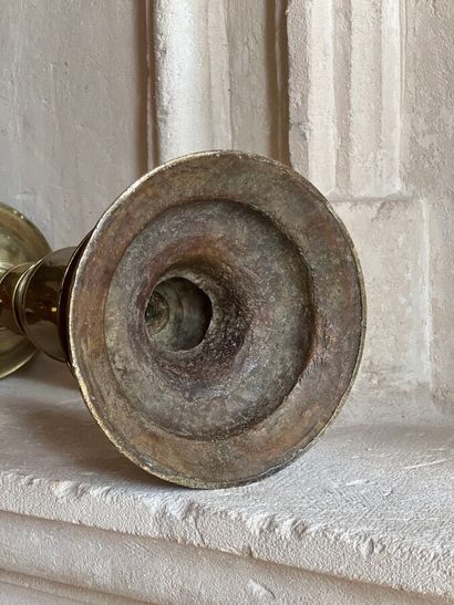 Brass pique-cierge with baluster shaft. The...