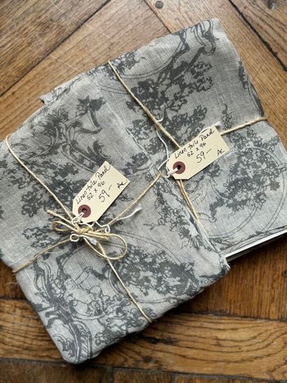 Two pieces of grey linen fabric with putti...