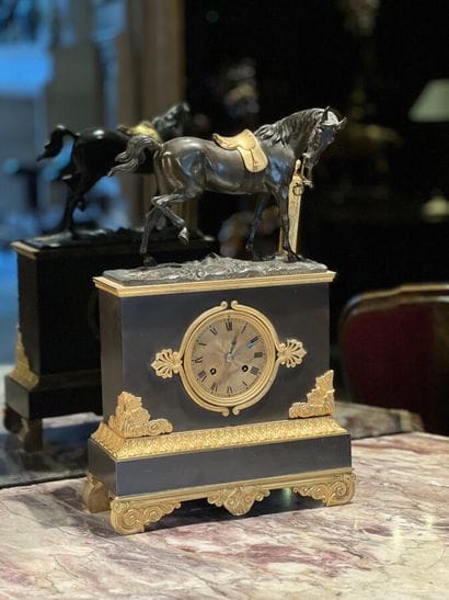 Patinated and gilded bronze clock decorated...