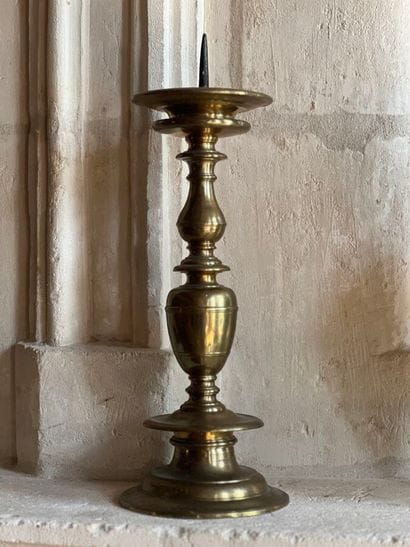 Brass pique-cierge with baluster shaft. The...
