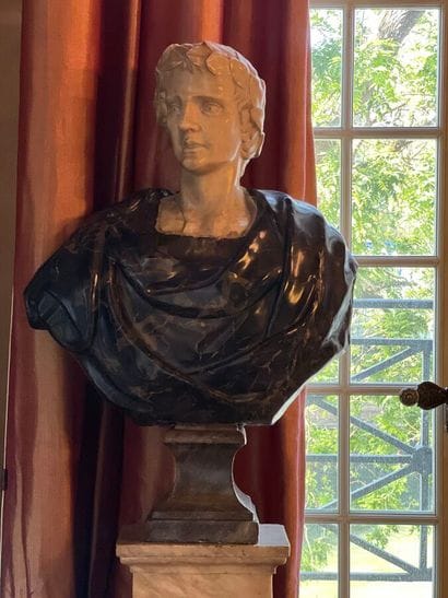Bust on pedestal carved in white and gray...