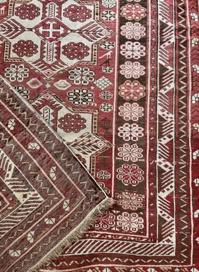 Oriental carpet with red background and central...