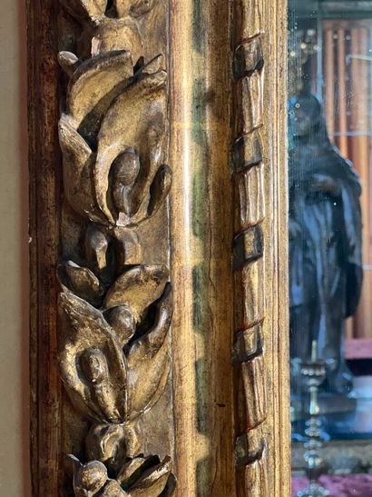 Grand miroir en bois sculpté et doré à décor...