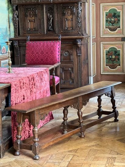 Natural wood bench decorated with carved...