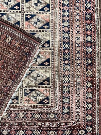 Oriental rug with a red background and blue...