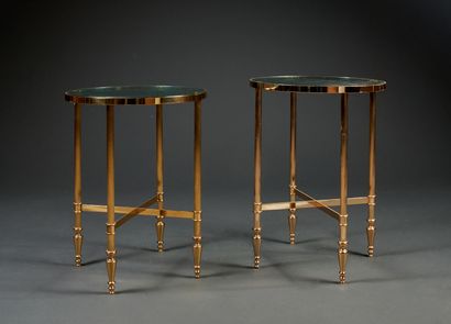 Two round pedestal tables in gilded metal,...