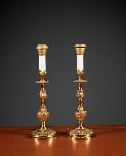 A pair of bronze baluster-shaped candlestick...