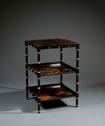 Black and gold pedestal table, forming the...