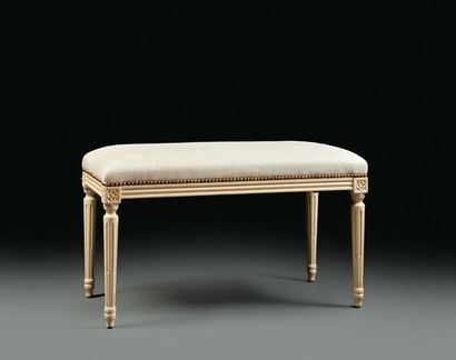 White lacquered molded wood bench in the...