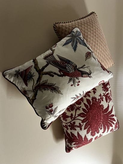 Three mismatched cushions, including two...