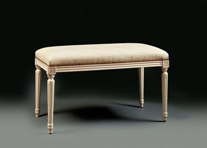 White lacquered molded wood bench in the...