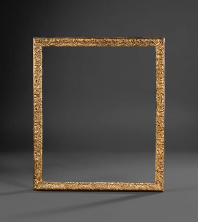Bérain molded and carved wood frame decorated...