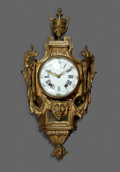Carved and gilded bronze wall clock topped...