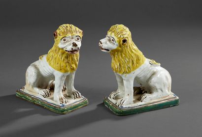Pair of statuettes of seated lions in polychrome-glazed...
