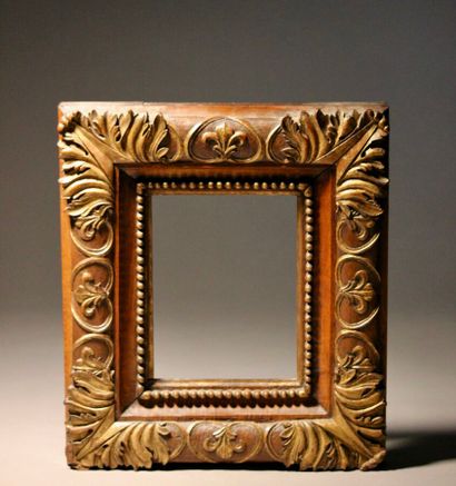 Walnut frame richly carved with accanthus...