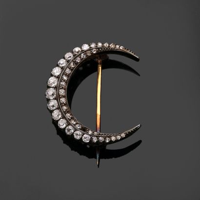 Silver and 18k (750 thousandths) gold crescent-shaped...