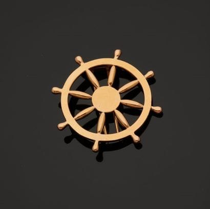 A vermeil brooch in the form of an eight-spoke...