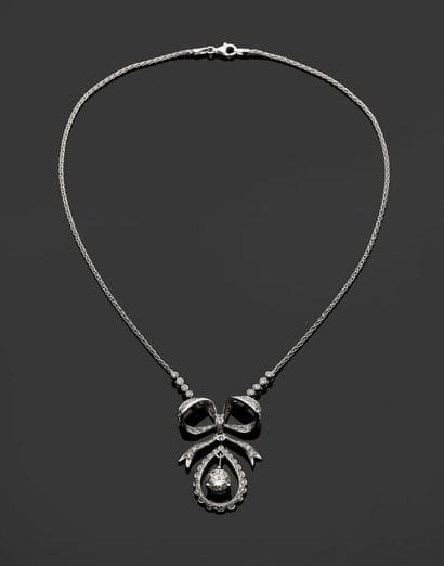 18k (750 thousandths) white gold bow necklace...