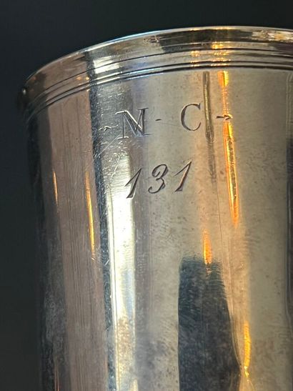 Silver tumbler monogrammed MC.131. The lip...