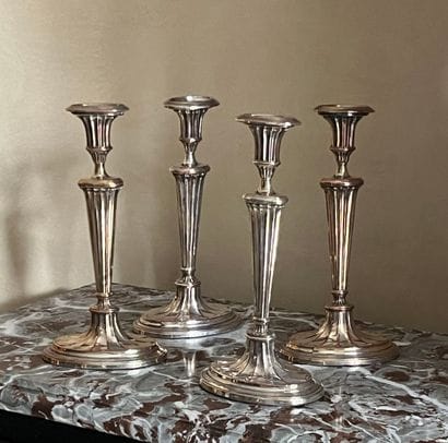 Four silver-plated torches, fluted shaft...