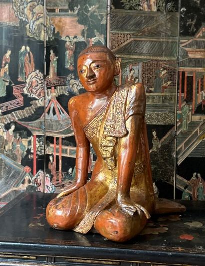 Two carved wood Buddhas lacquered in red...