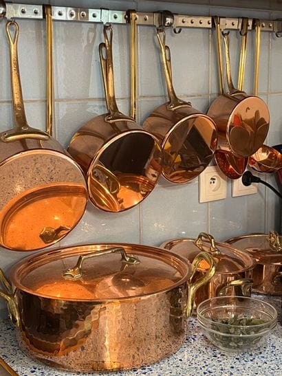 Set of copper saucepans