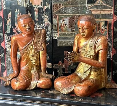 Two carved wood Buddhas lacquered in red...