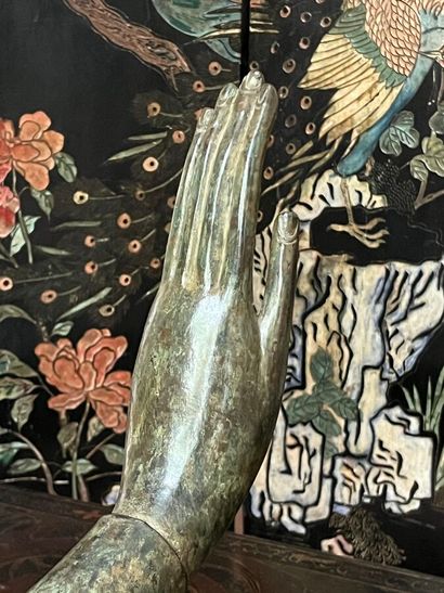 Fragmentary bronze hand resting on a pedestal...