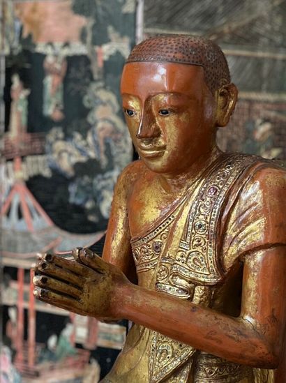 Two carved wood Buddhas lacquered in red...