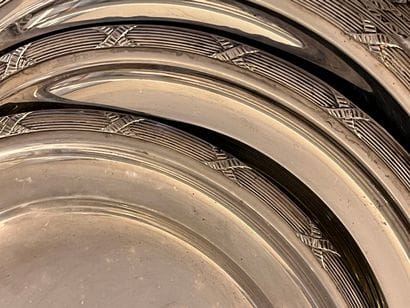 Eighteen silver plated plates decorated with...