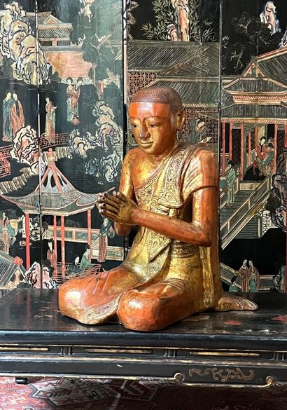 Two carved wood Buddhas lacquered in red...