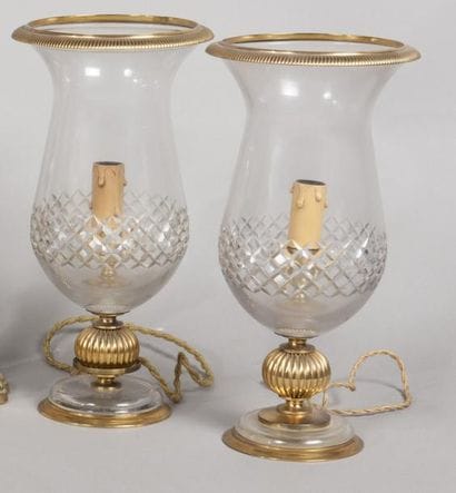 Deux photophores en cristal et cuivre doré....