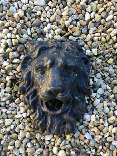 Un mascaron en fonte représentant une tête...