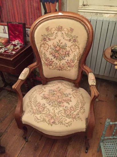 Un fauteuil en bois naturel recouvert d'une...
