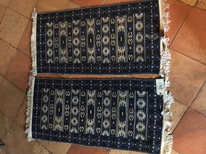 Une paire de tapis en laine à fond bleu....
