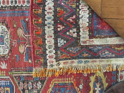 TAPIS Kilim à fond rouge à décor stylisé...