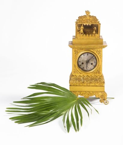 Pendule en bronze doré et ciselé. A l'amortissement,...