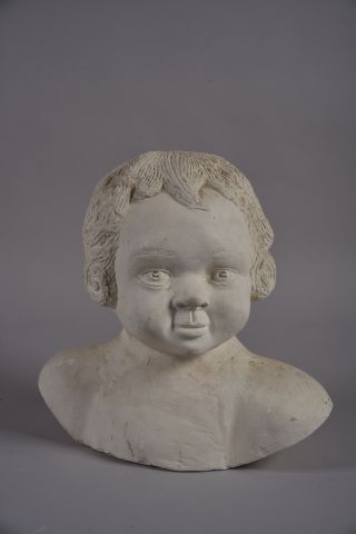 Buste d'enfant en plâtre. Signé sur l'épaule....