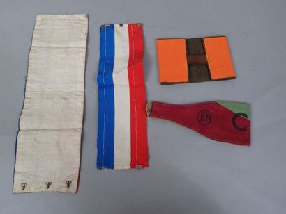 Lot de trois brassards : un en tissu rouge...
