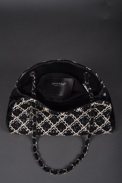 CHANEL
Black patent leather bag quilted on...