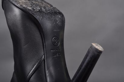 CHANEL
Pair of black leather boots, strap...